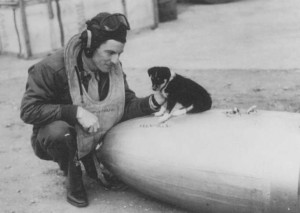 Unidentified US pilot at Leiston, between June 1943-45. The puppy sits on a drop-tank.